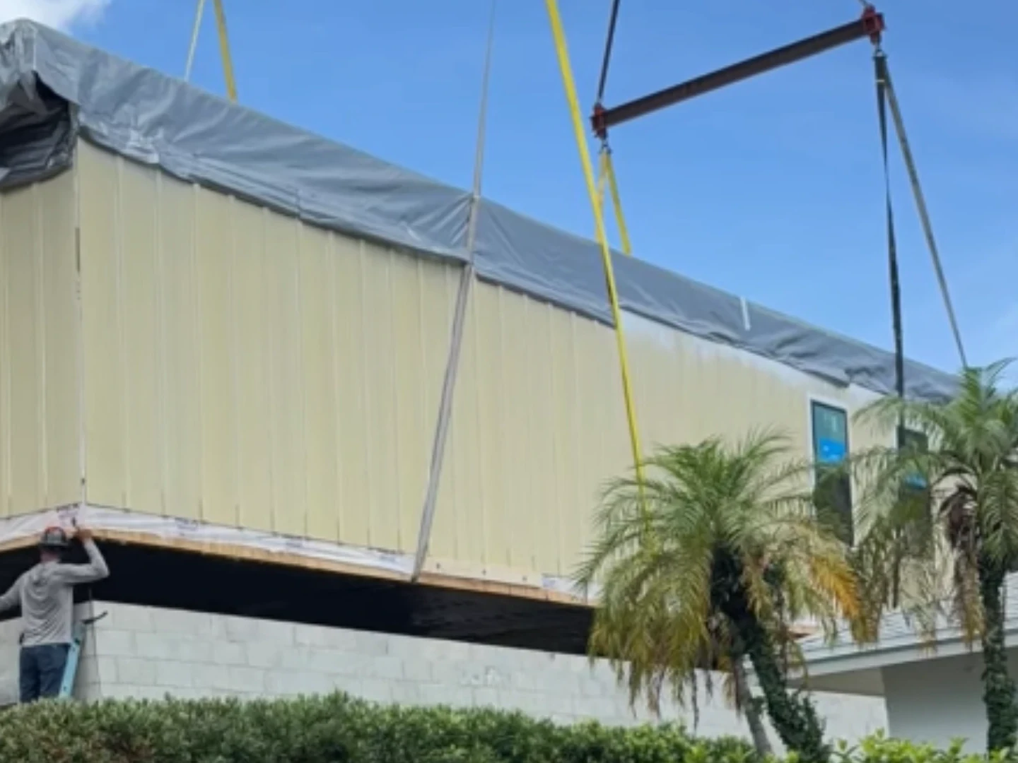 Crane setting a living space section onto an elevated foundation during Seasafe coastal home construction